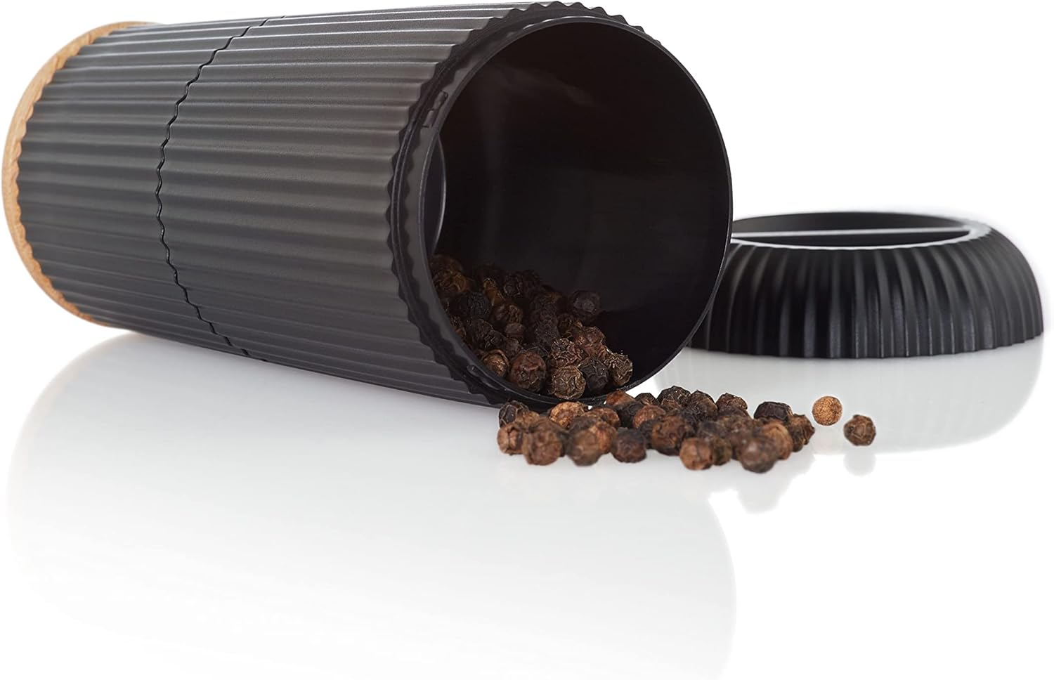 AdHoc Scape mill lying on its side with peppercorns spilled out, showing the transparent chamber