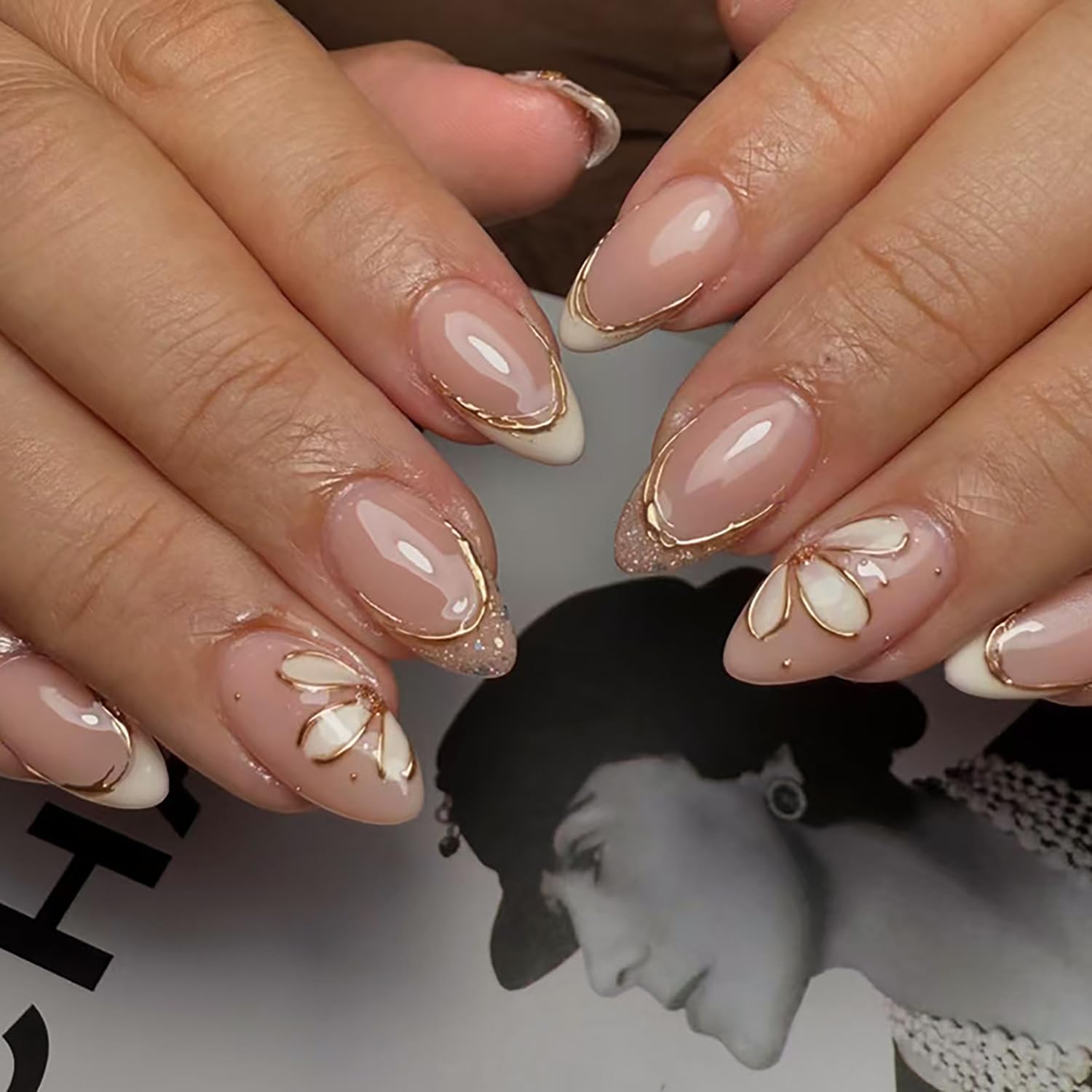 Photo 1 of 24Pcs Almond Press on Nails Short Length White French Tip Fake Nails with Glitter Designs Gold Line Flower Acrylic Nails Full Cover Spring False Nails White Floral Stick on Nail for Women Nail Decor
