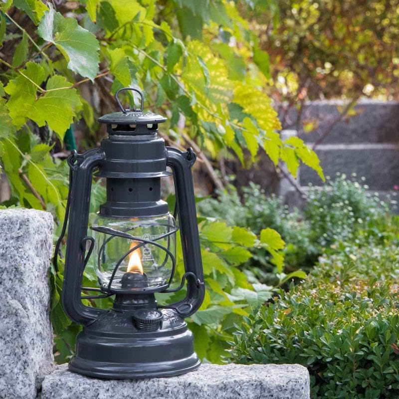 Feuerhand Baby Special 276 lantern on a stone wall in a garden