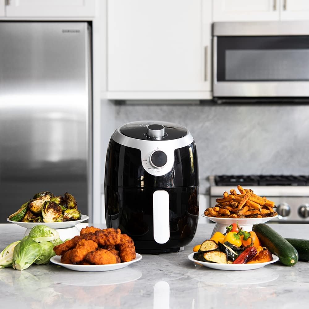 YEDI HOUSEWARE GV030 Air Fryer on counter with various cooked foods