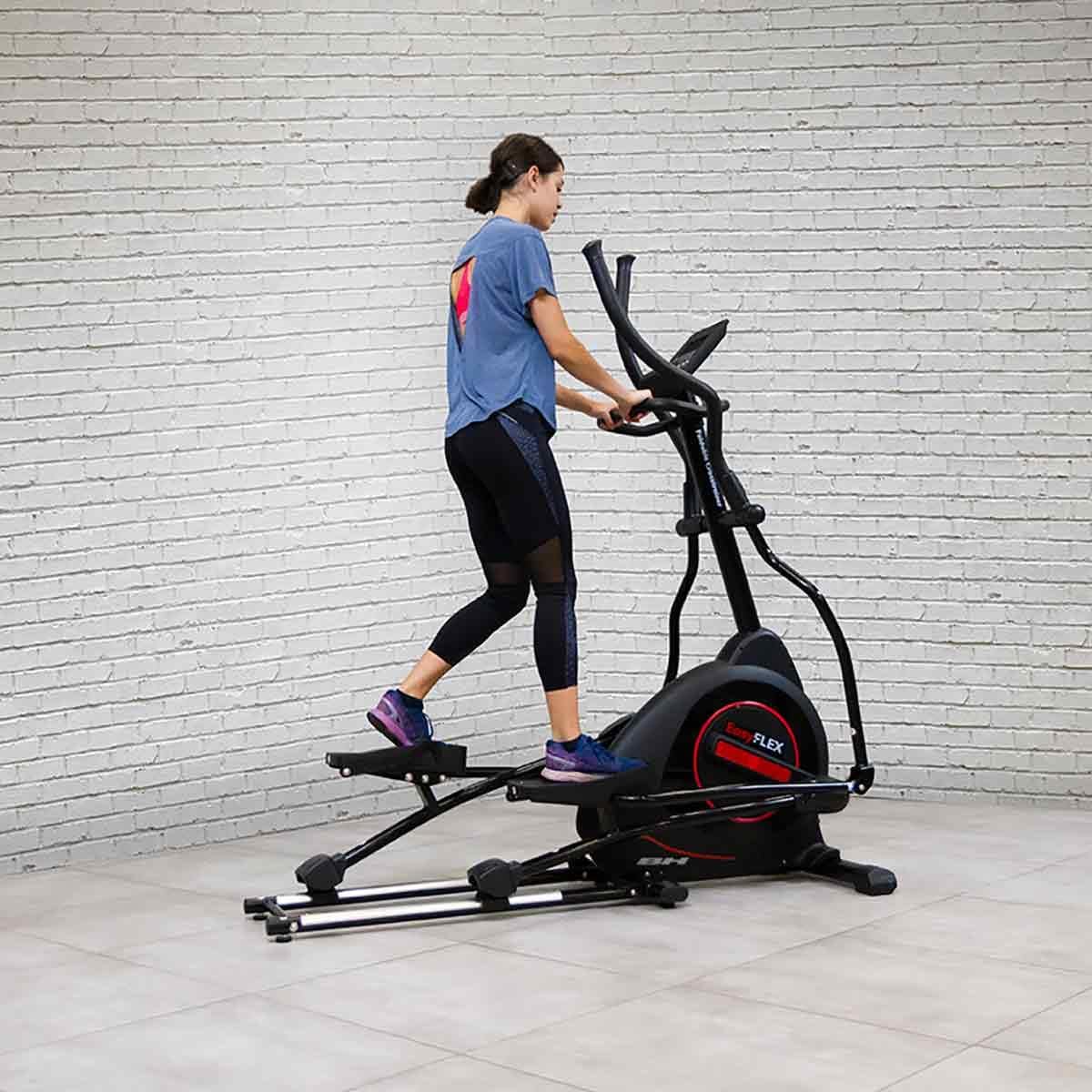 User exercising on the BH Fitness Easy Flex G852 Elliptical Trainer