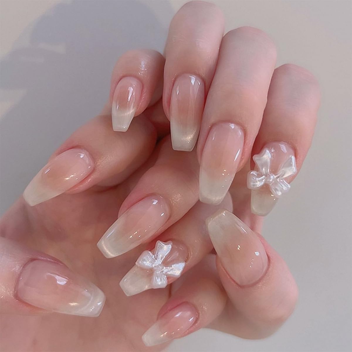 GlamRays 24 Pieces French Press on Nails Medium Coffin Shape Fake Nails with Cute Bow Nail Charms Rhinestones Designs Acrylic nails Glossy Nude Pink False nails Reusable Stick On nails