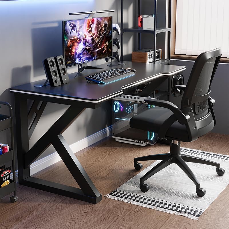 A complete gaming setup on the Deli Gaming Table, showing a monitor, keyboard, mouse, speakers, and a gaming chair.