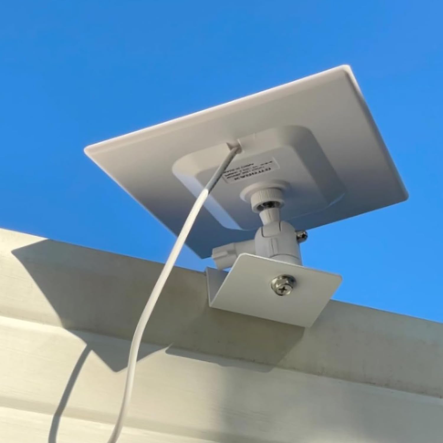 Tonton Gutter Mount with a security camera attached, installed on a house gutter.