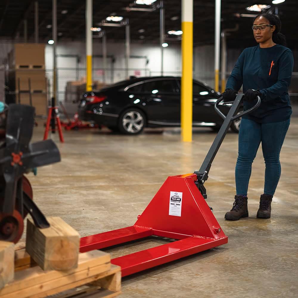 Person operating pallet jack with a load