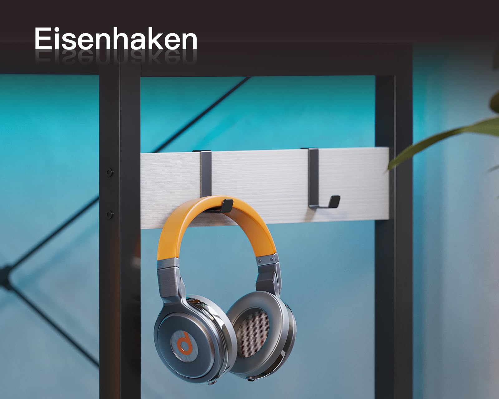 Close-up of the iron headphone hook attached to the ODK Corner Desk frame, with a pair of headphones hanging from it.