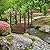 Outsunny 7.5' Fir Wood Garden Bridge Arc Walkway with Side Railings, Perfect for Backyards, Gardens, & Streams, Carbonized