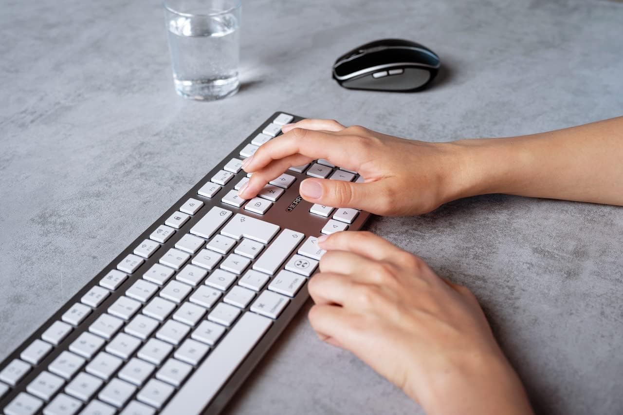 Hands typing on the Cherry KW 9100 keyboard