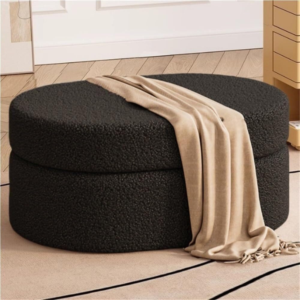 Bout de lit ottoman ovale noir compact pour ranger vos affaires dans les petits espaces