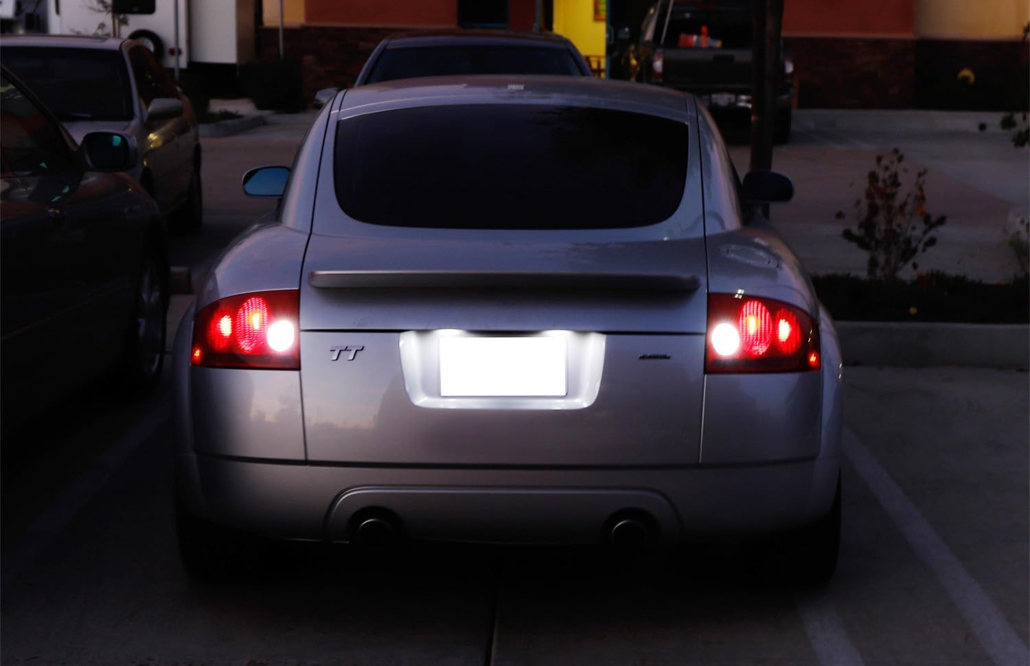 Audi TT with bright LED license plate lights at night