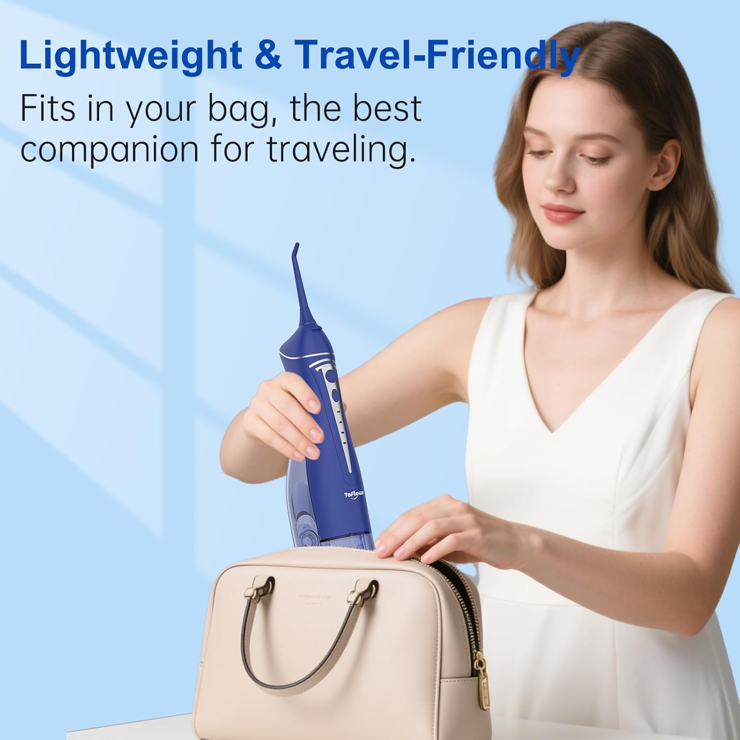 A hand using the provided cleaning brush to clean the detachable water tank of the ToFlow water flosser.