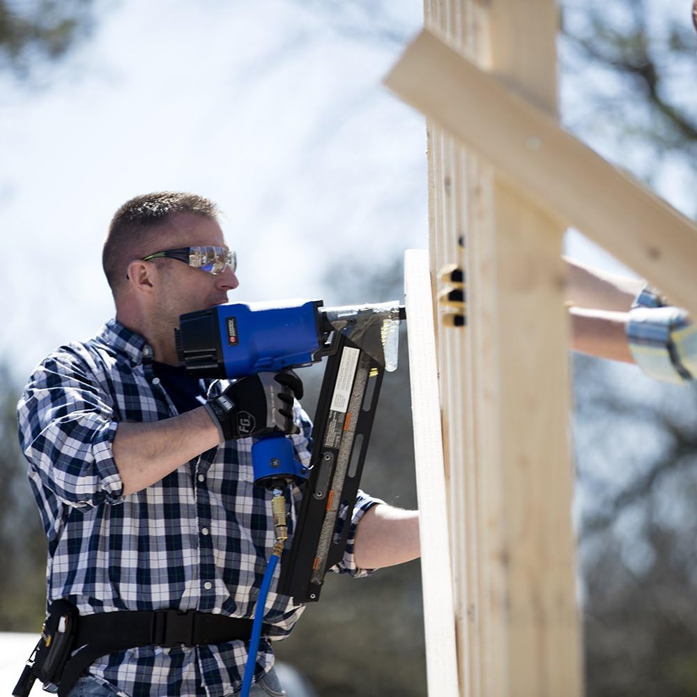 Man operating Campbell Hausfeld framing nailer on a wooden structure