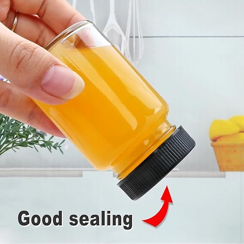 Miniatura 5 de QAPPDA Botellas de vidrio de 2 onzas, botellas pequeñas de jugo de vidrio con tapas negras para líquidos, botellas de muestra de chupito, a prueba