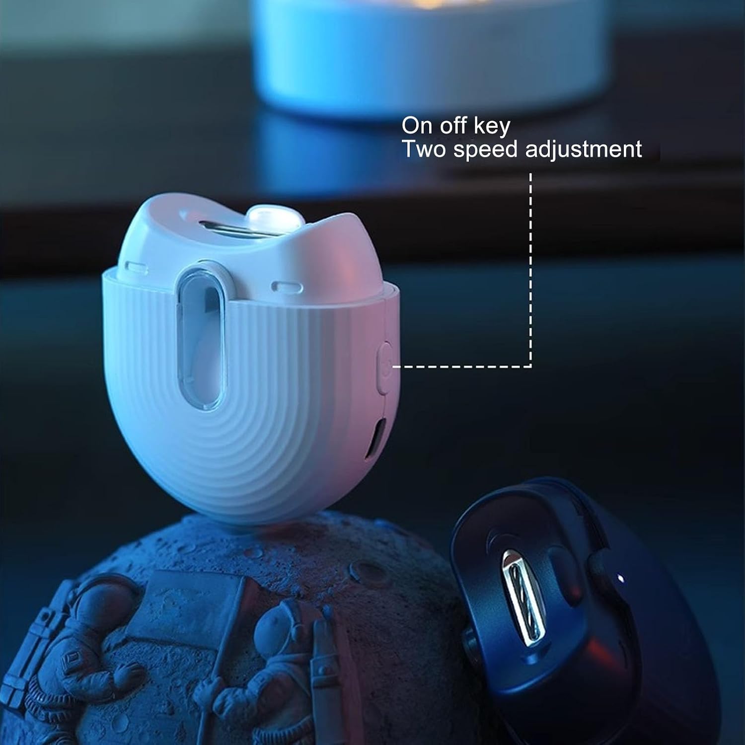 വശം view of the ZJchao Electric Nail Clipper showing the on/off key and two-speed adjustment button.