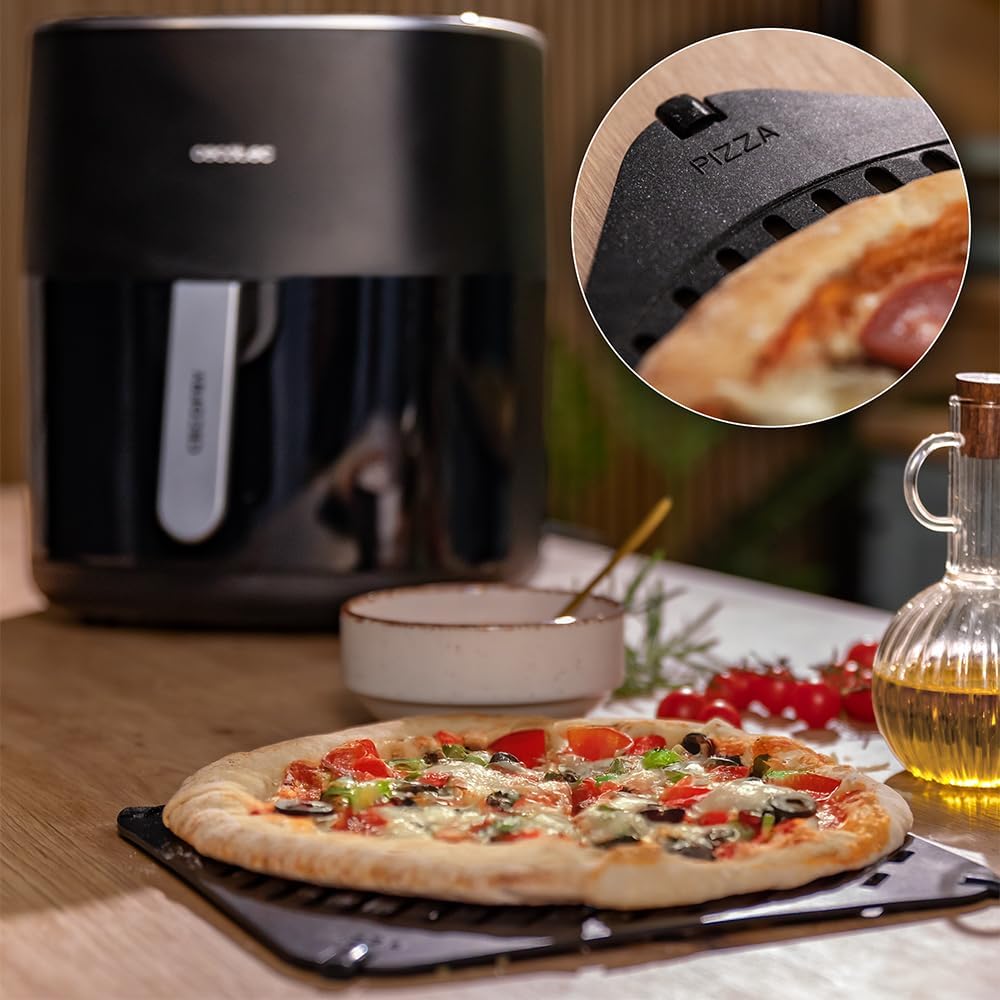 A pizza being cooked on a specialized tray inside the Cecotec air fryer.