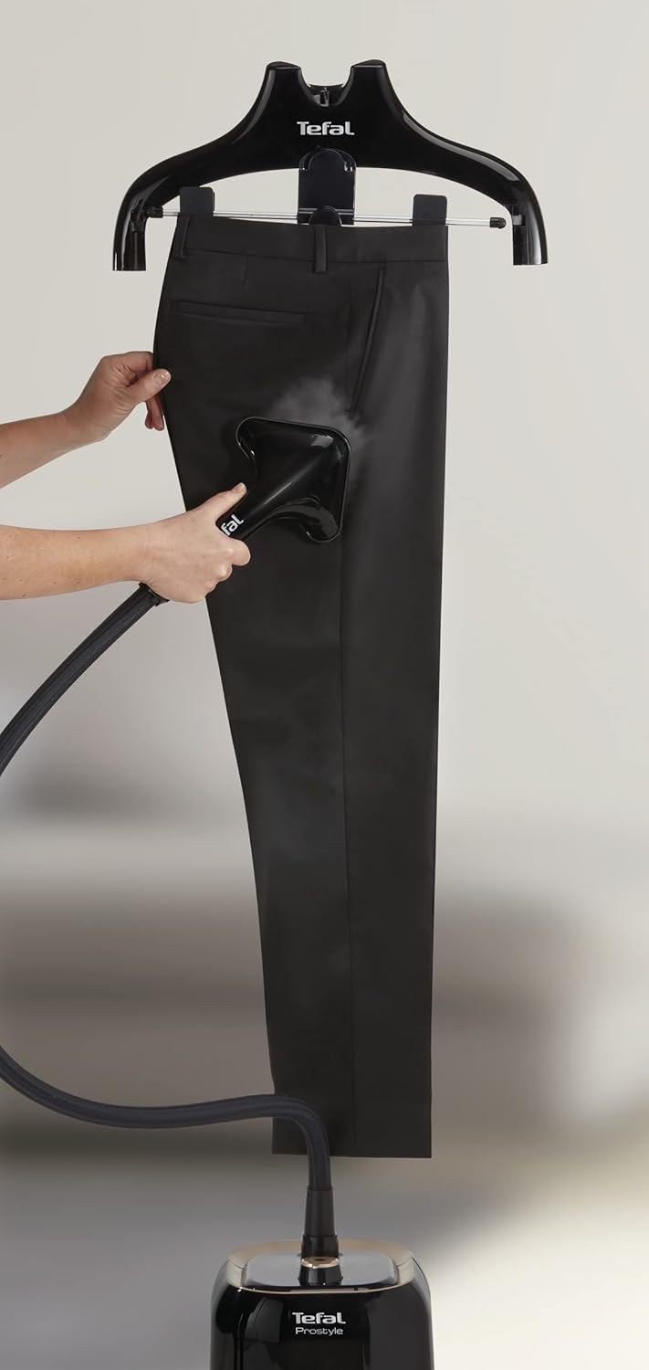 Hand removing the water tank from the base of the Tefal ProStyle Garment Steamer.