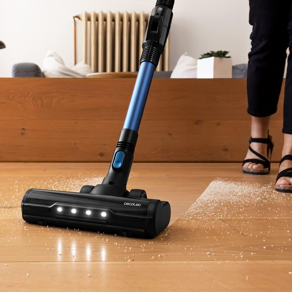 Cecotec Conga Rockstar 990 Advance Ergoflex vacuum cleaner in use on a wooden floor, showing the illuminated main brush