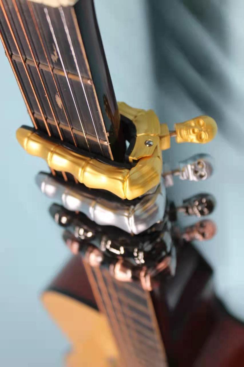 Geva - Pomo de calavera para guitarra acústica y eléctrica, universal, 4, 5, 6, 12 cuerdas, instrumentos, cejillas, bajo, ukelele, mandolina, banjo... (bronce)