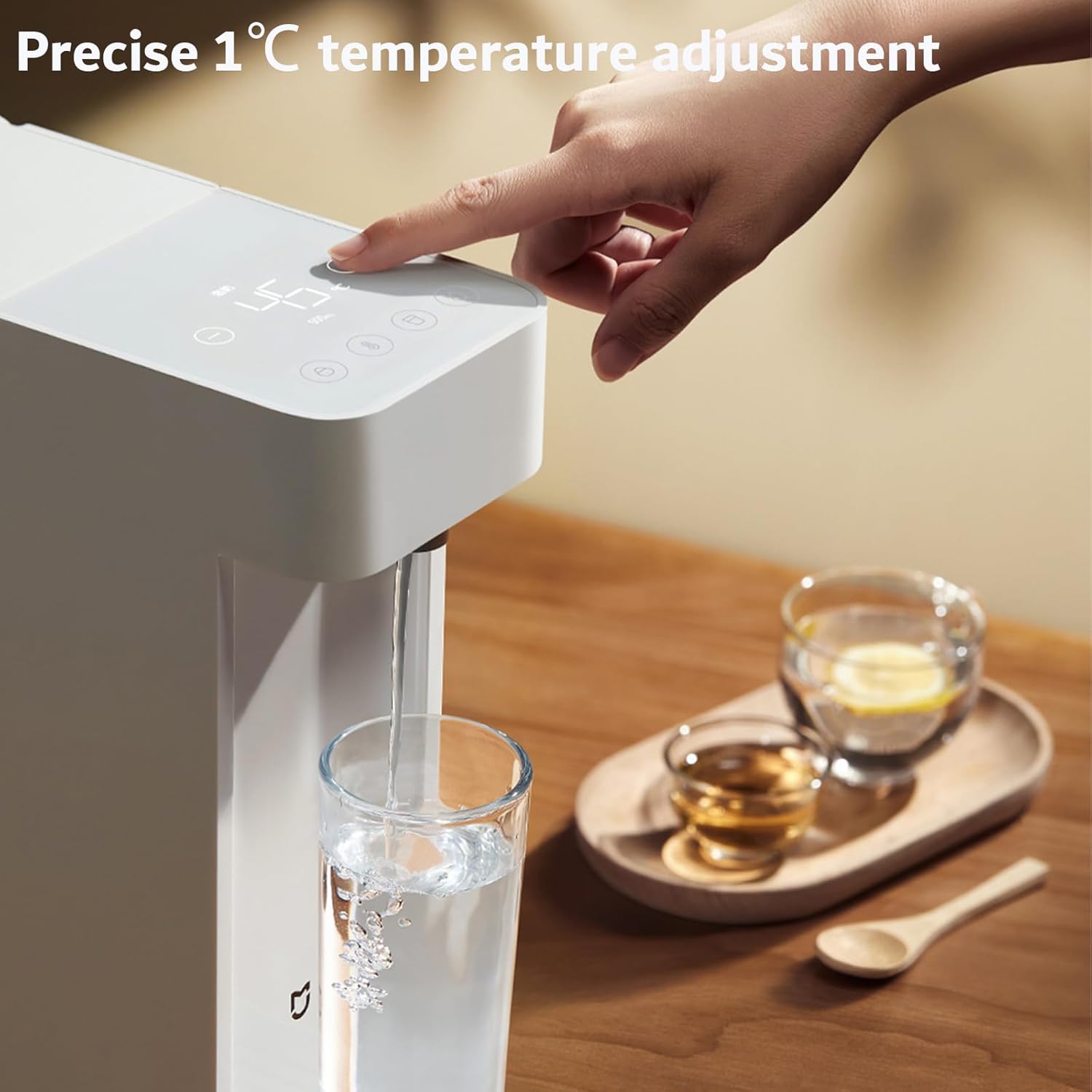 Hand pressing a button on the dispenser's control panel to adjust temperature