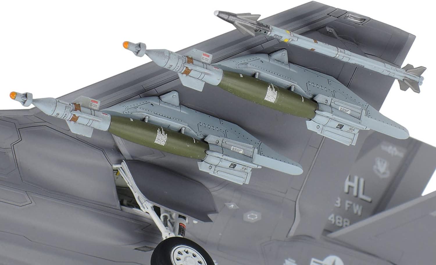Underside view of the F-35A model showing external weapons mounted on the wings and landing gear deployed.