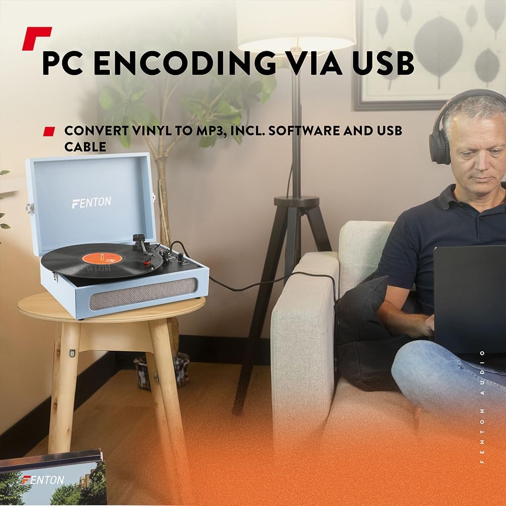 A person using a laptop to convert vinyl to MP3 via USB connection to the Fenton RP118E record player.