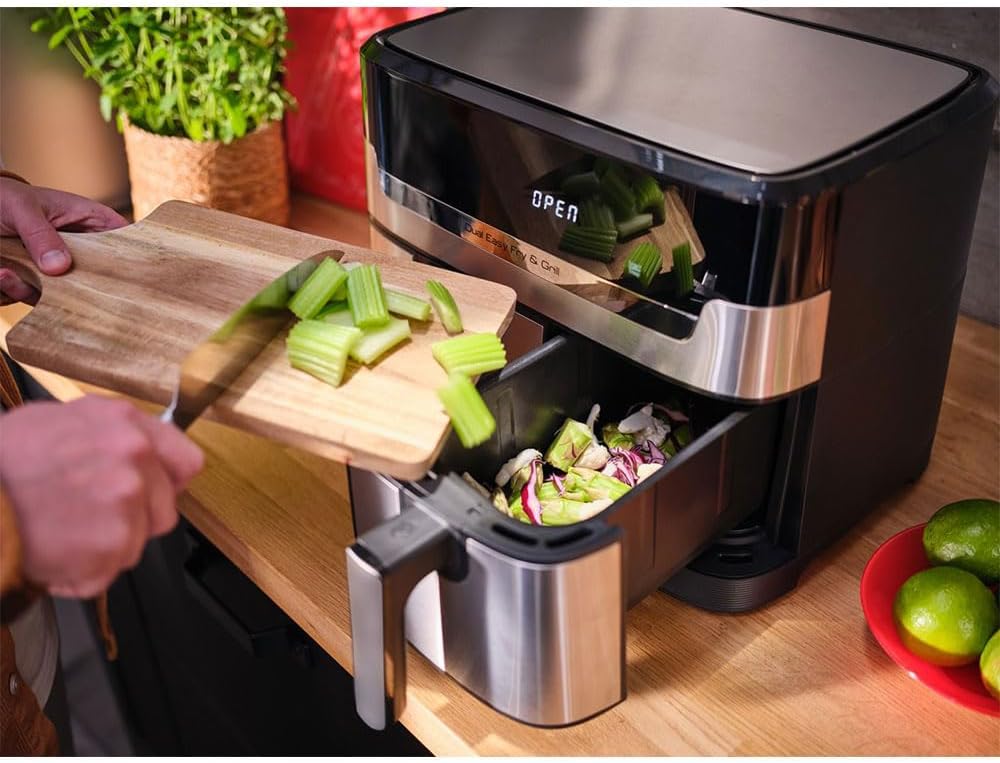 A hand adding chopped vegetables to one of the cooking baskets of the Tefal Dual Easy Fry & Grill.