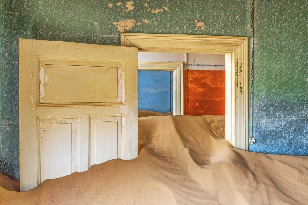 Africa, Namibia, Kolmanskop. Doorways and drifting sand in an abandoned diamond mining town. Poster Print by Jaynes Gallery (24 x 36)