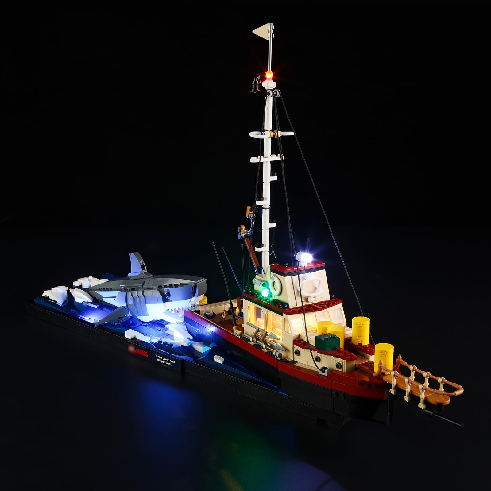 YEABRICKS LED Light Kit installed on the 21350 Ideas Jaws Building Blocks Model, showing the boat and shark illuminated in a dark setting.