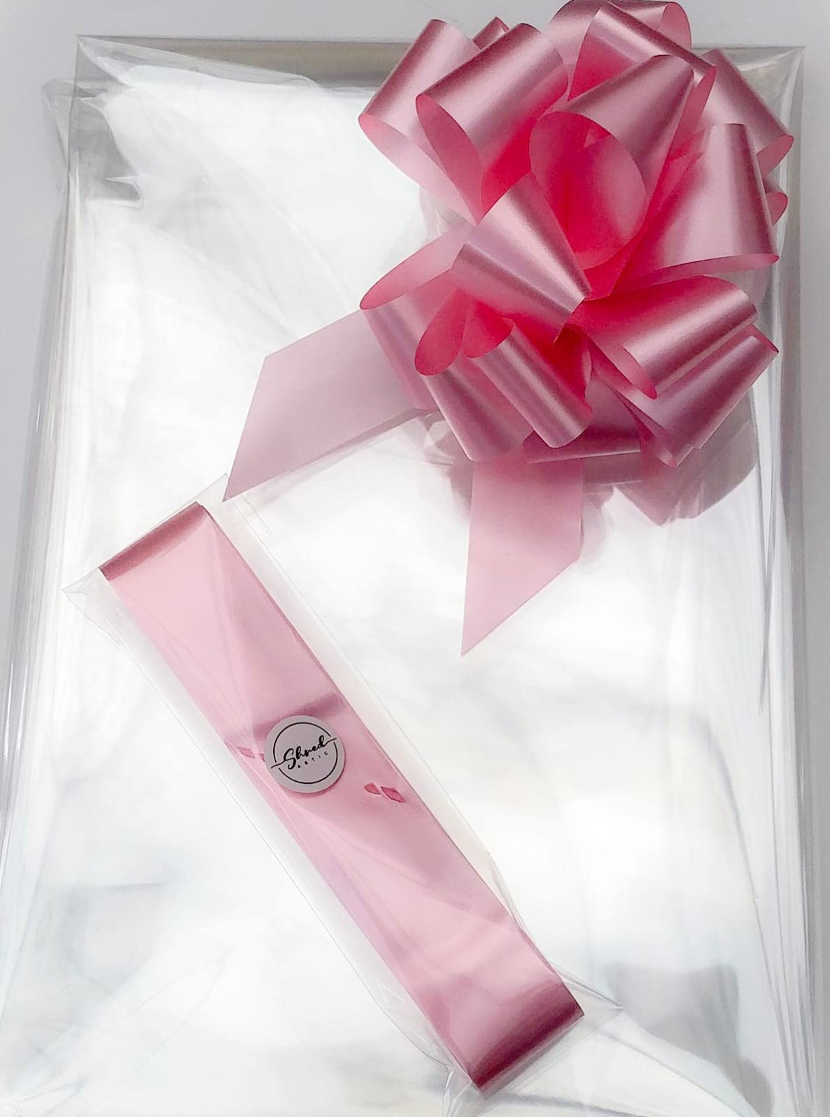 ShredAstic® Clear Florist Cellophane wrap with 30mm Pull Bow (2 metres, Pale Pink)