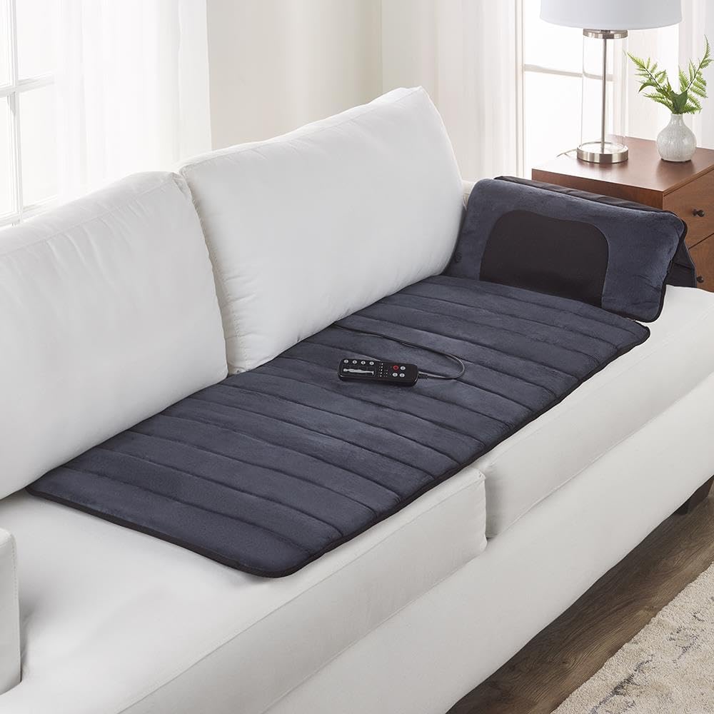 Massage mat laid flat on a white couch