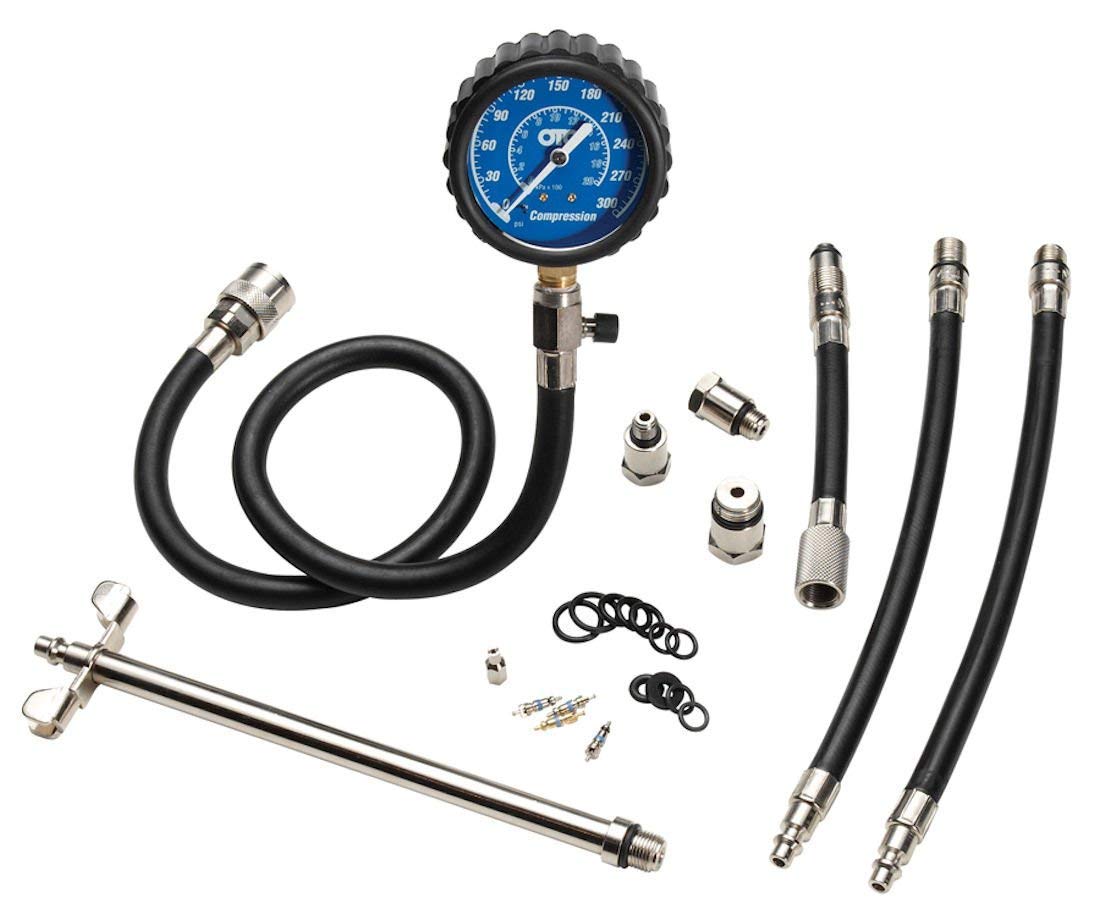 All components of the OTC 5605 Deluxe Compression Tester Kit laid out