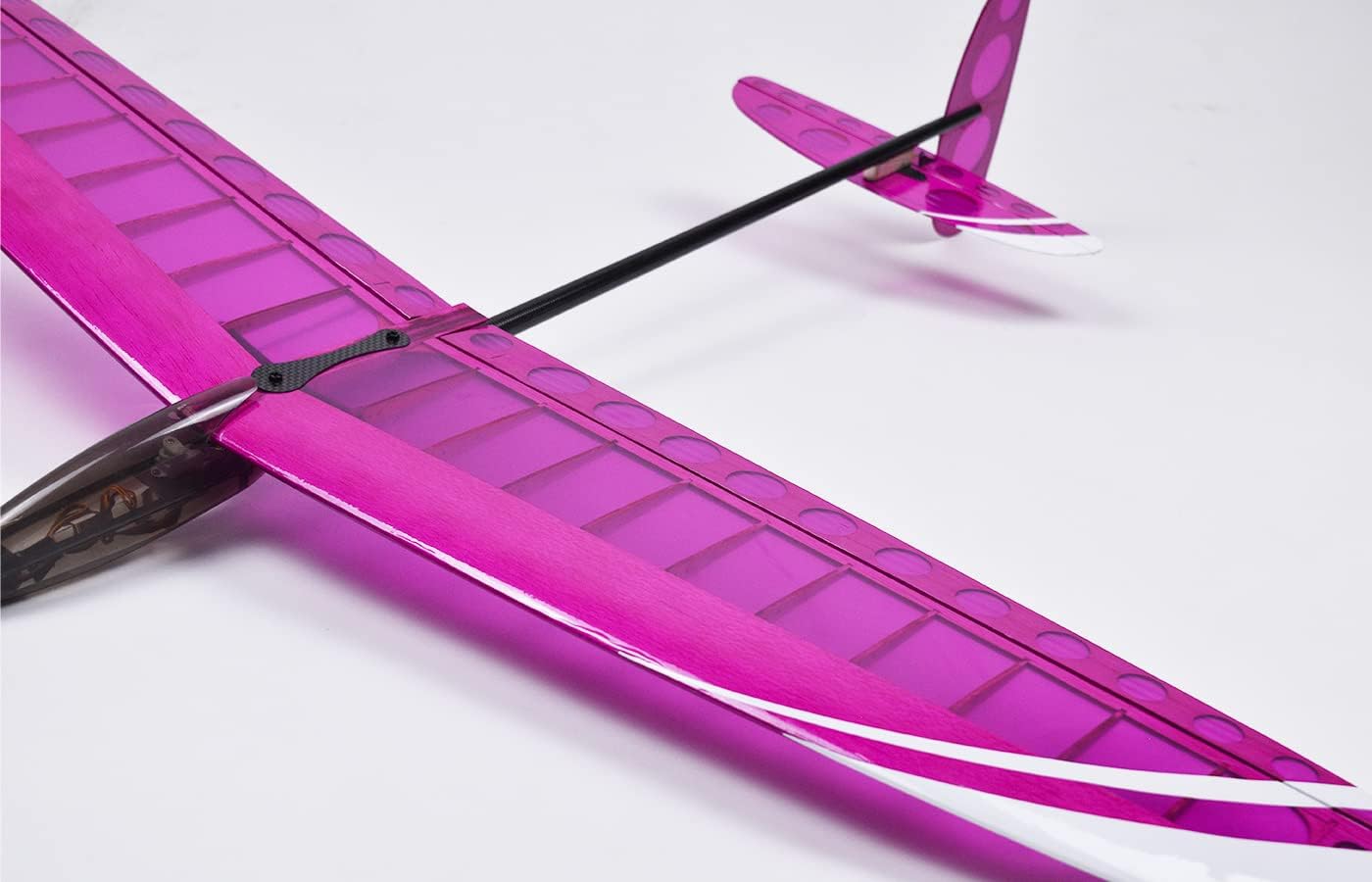Close-up view of the MODSTER Discus Acro wing and fuselage connection, showing the carbon fiber reinforcement.