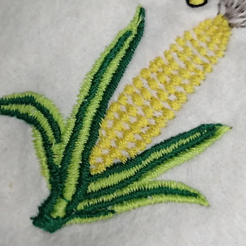 Close-up of an embroidered cartoon figure design on white fabric