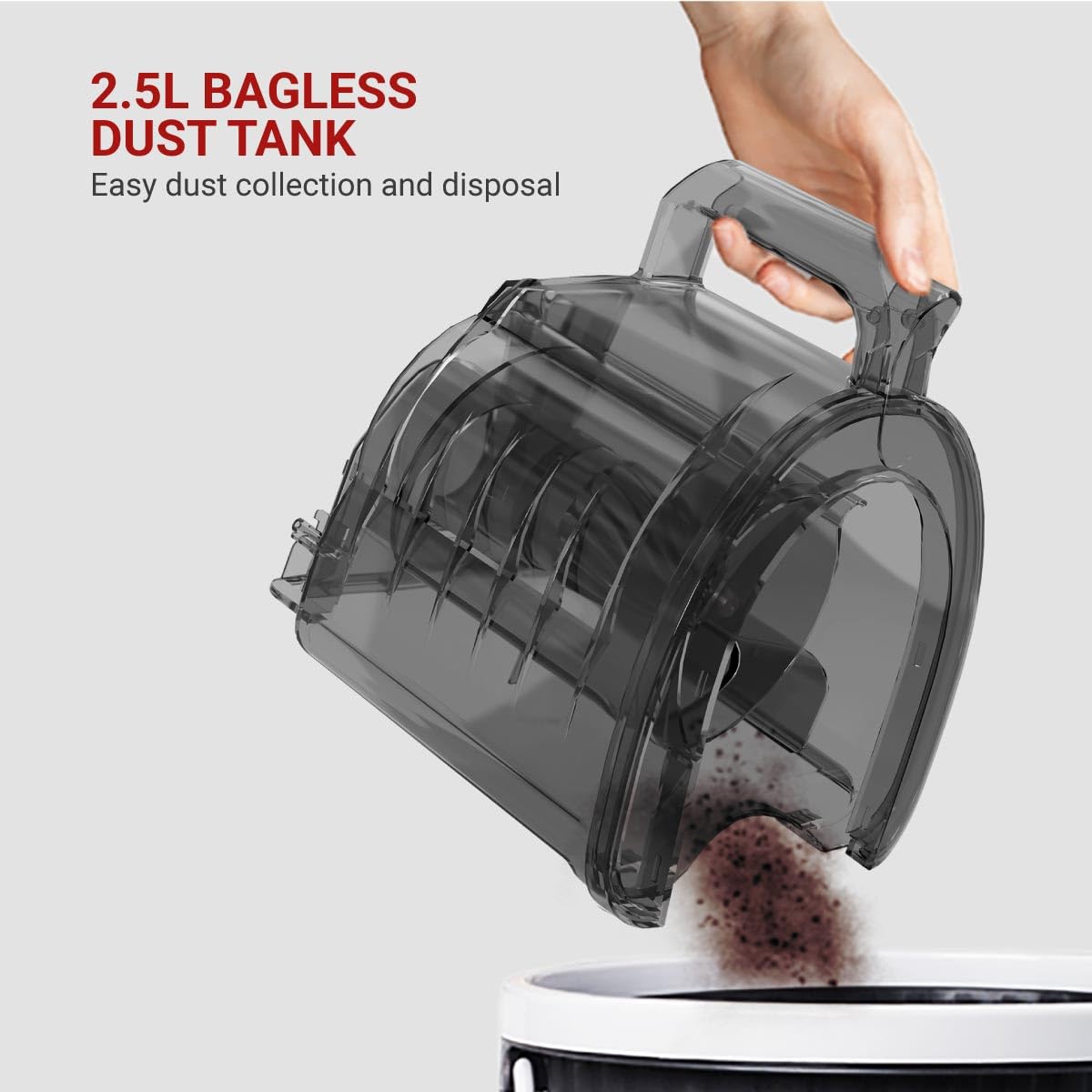 Hand emptying the 2.5L bagless dust tank into a bin