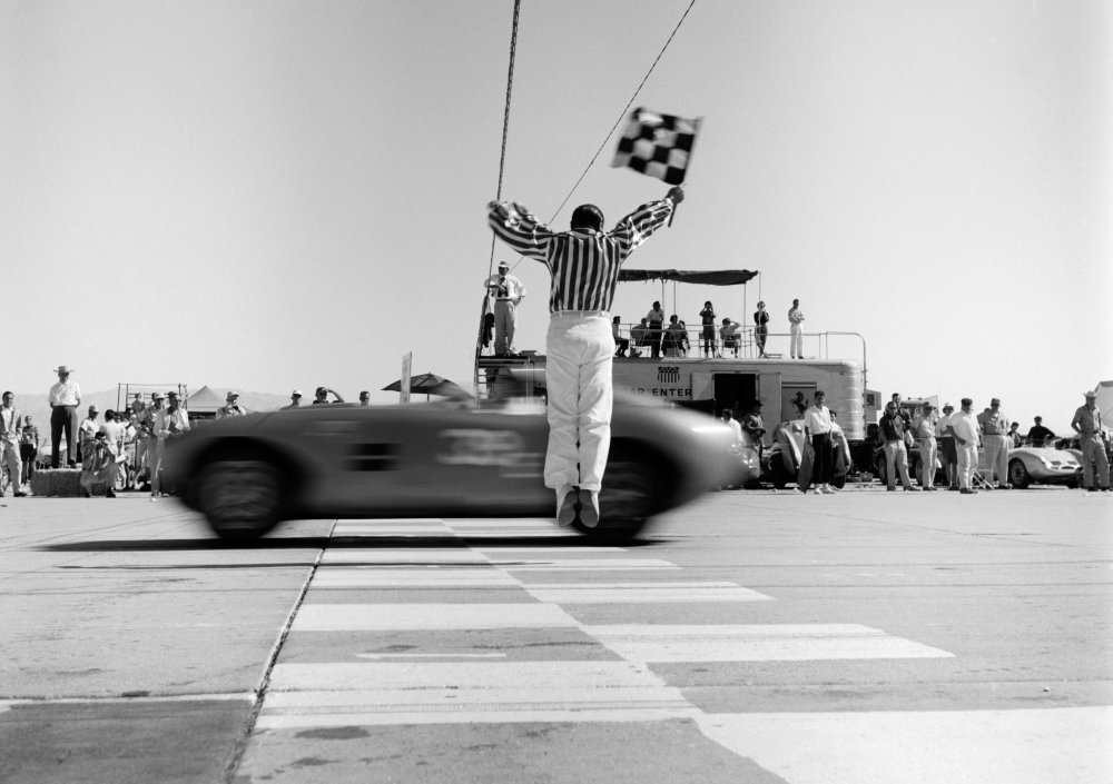 Amazon.com: 1960s Man Jumping Waving Checkered Flag For Winning