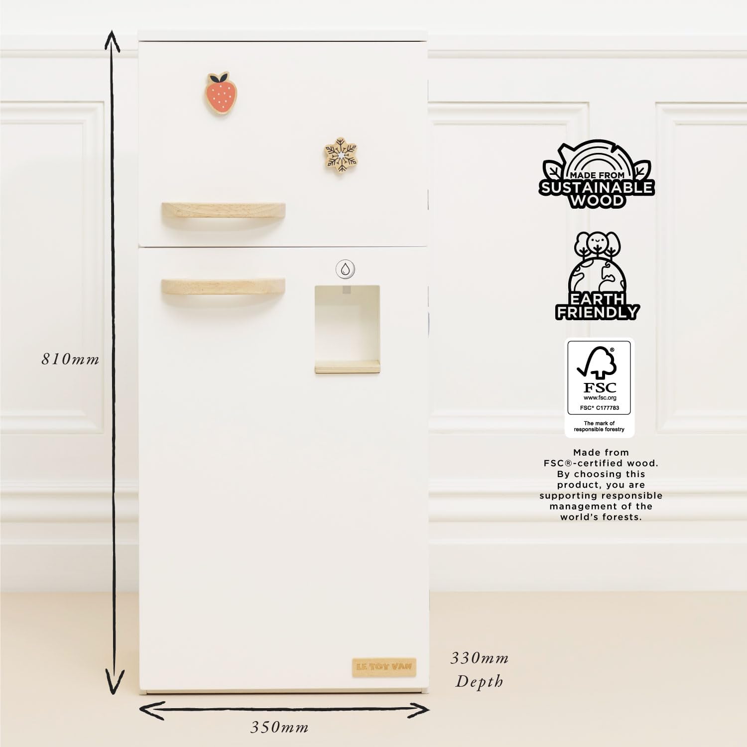 Diagram showing the dimensions of the Le Toy Van Wooden Fridge Freezer: 810mm height, 350mm width, and 330mm depth. Also highlights 'Made from Sustainable Wood' and 'Earth Friendly' logos.