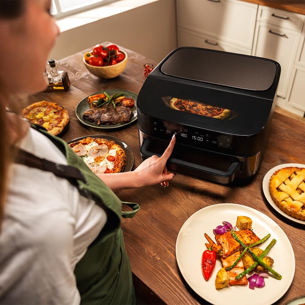 Hand interacting with Cecotec Pizza&Fry 7000 touchscreen control panel