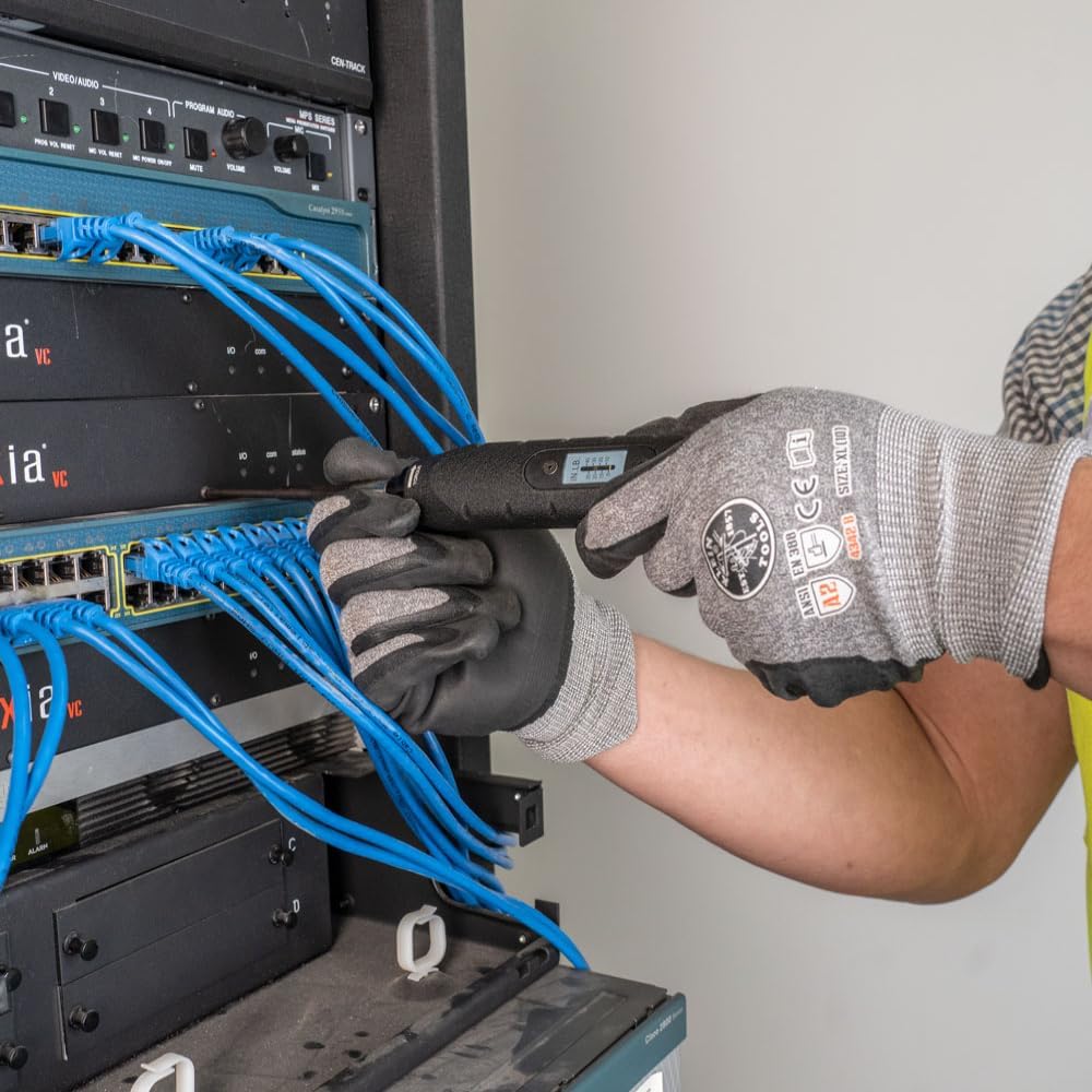 Person using Klein Tools torque screwdriver on network equipment