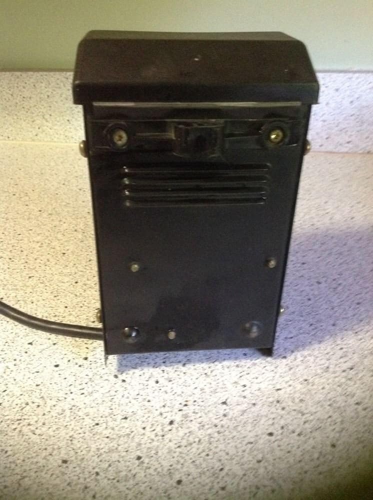 Od blizu view of the internal timer dial and instruction label inside the Intermatic LV371T transformer lid.