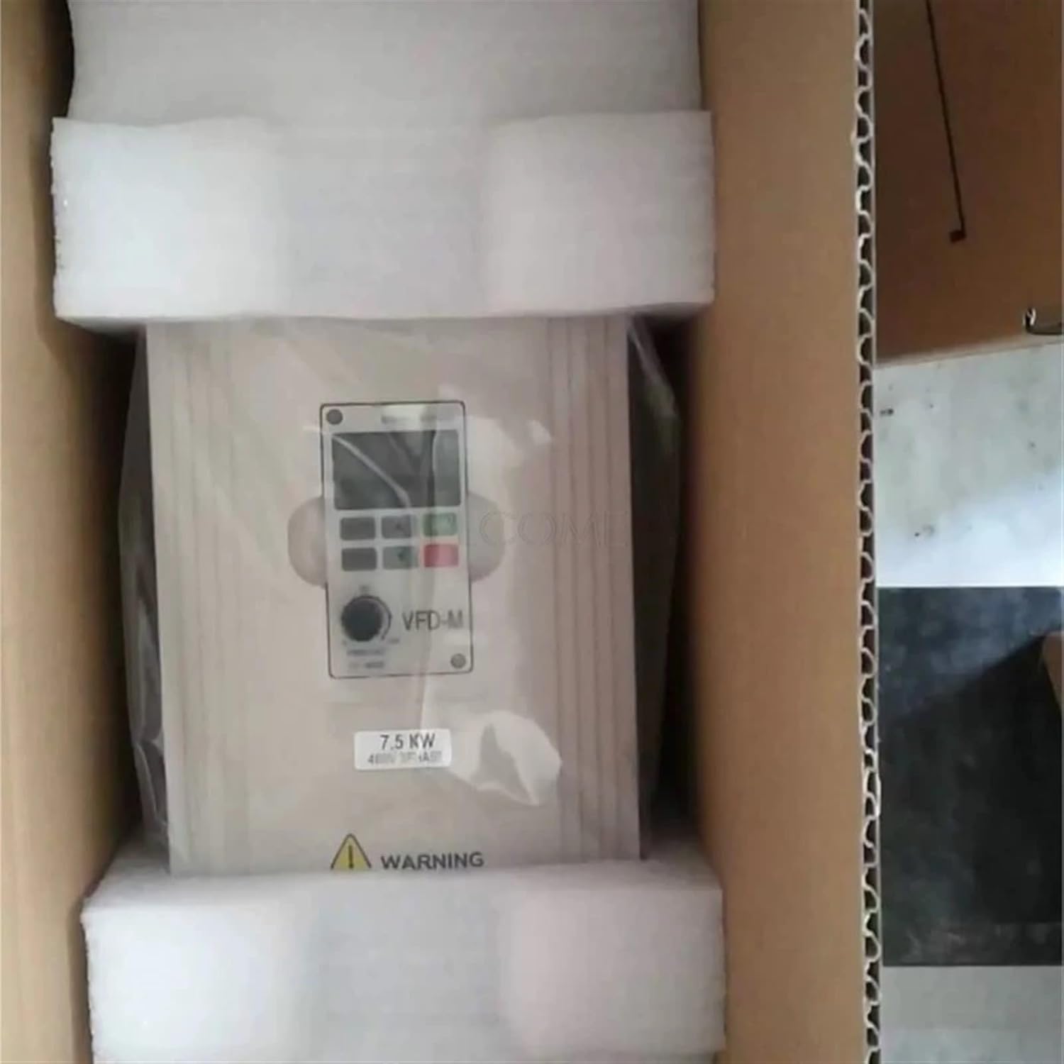 VFD-M Series Frequency Inverter securely packaged in a cardboard box with foam inserts.
