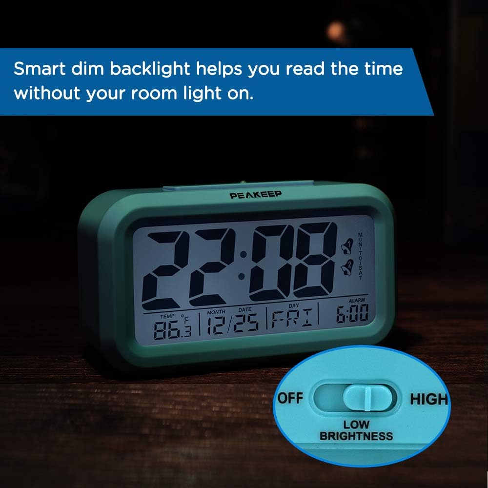Peakeep Digital Alarm Clock in a dim room with its smart dim backlight activated, showing the low brightness switch.