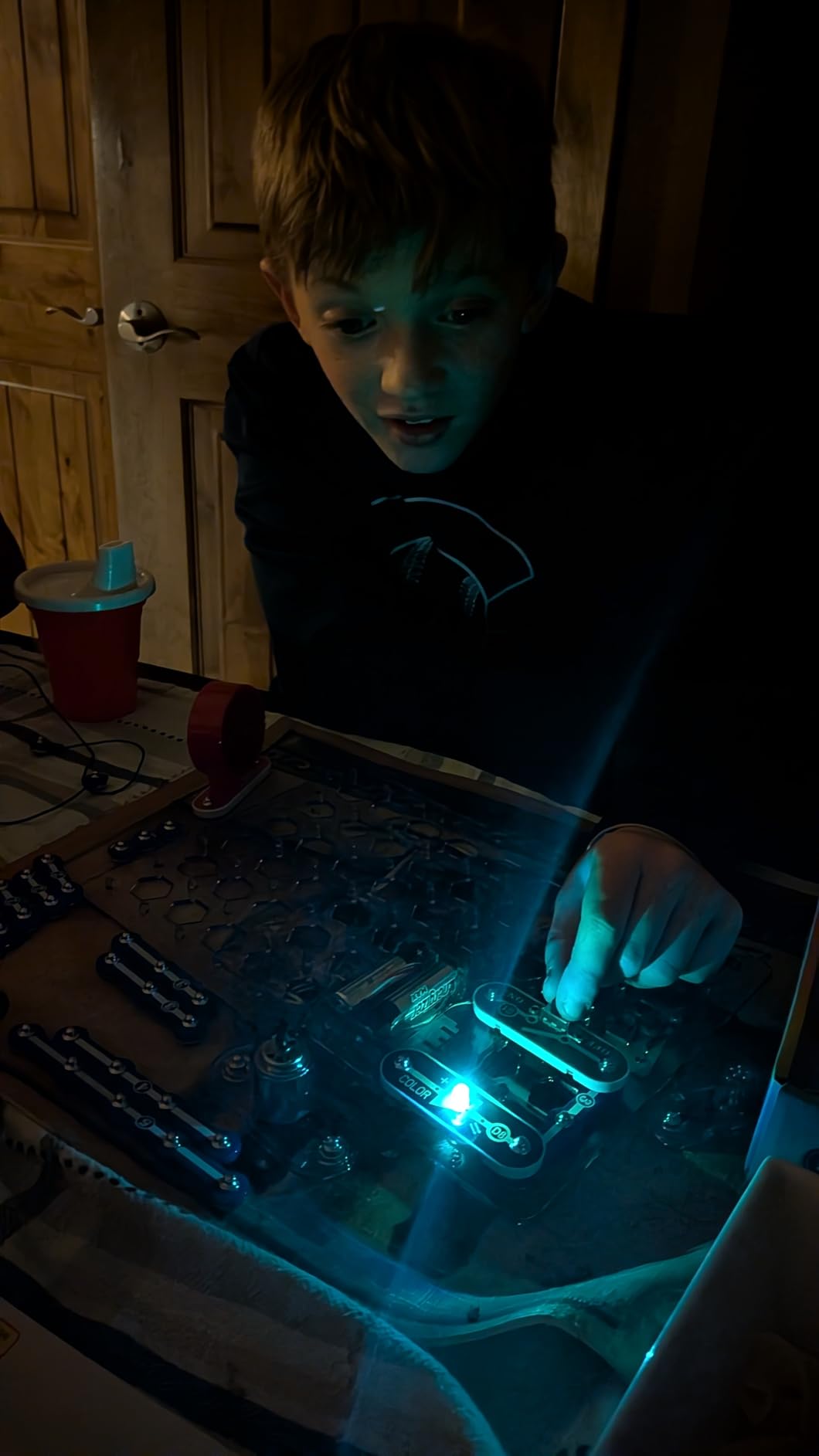 Snap Circuits Jr. SC-100 in action showing the color-coded components snapped onto the plastic grid board
