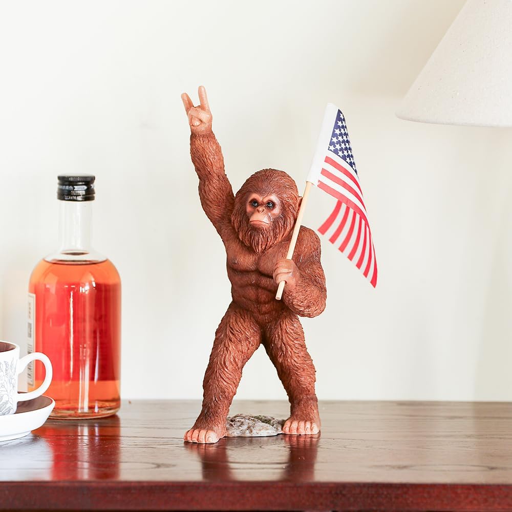 The Bigfoot Statue Holding The National Flag, A 10.4-Inch Resin Statue, Sasquatch Gifts. Bigfoot Decor is Suitable for Outdoor and Indoor Decor. Father's Day