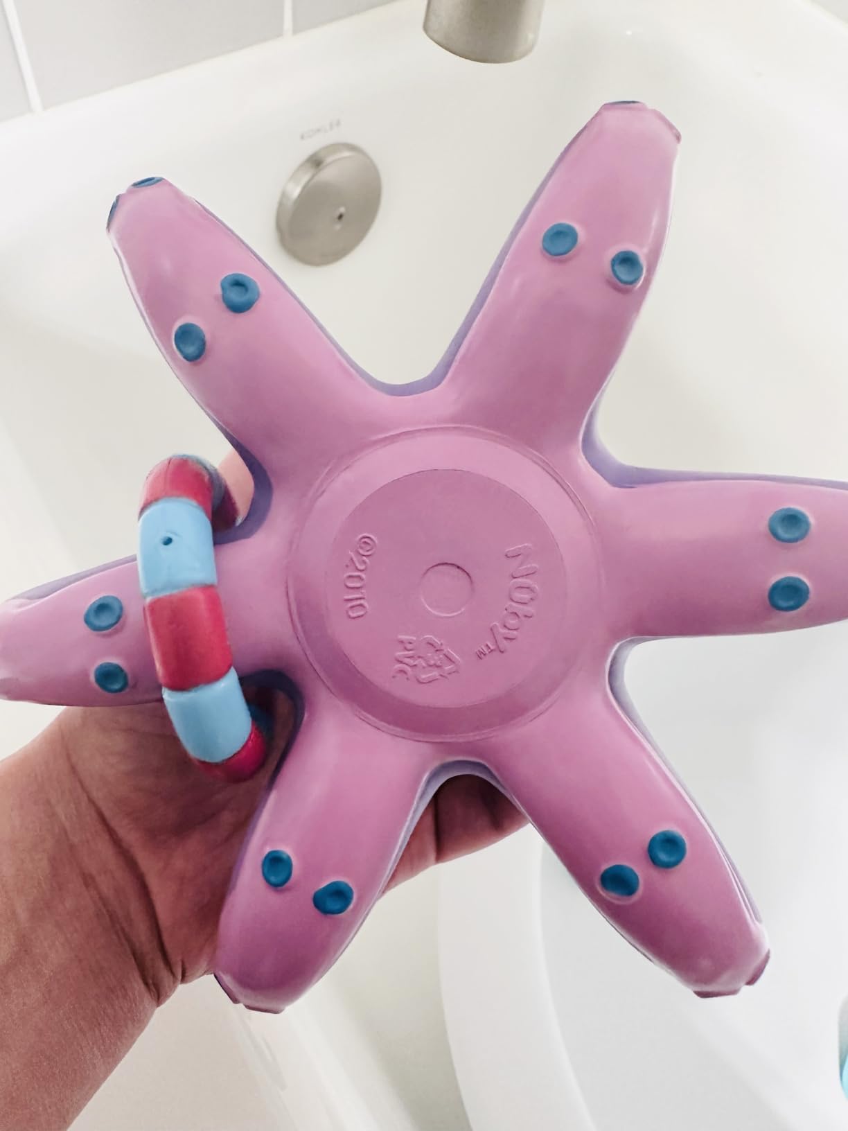 Toddler playing with Nuby Octopus Bath Toy