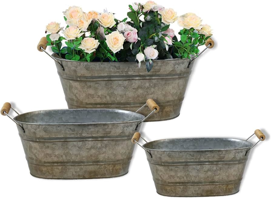 Three galvanized metal buckets arranged by size showing reflective metal finish