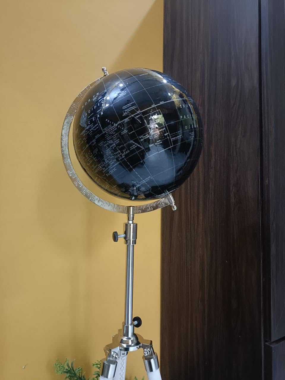 World Black globe with white tripod stand.