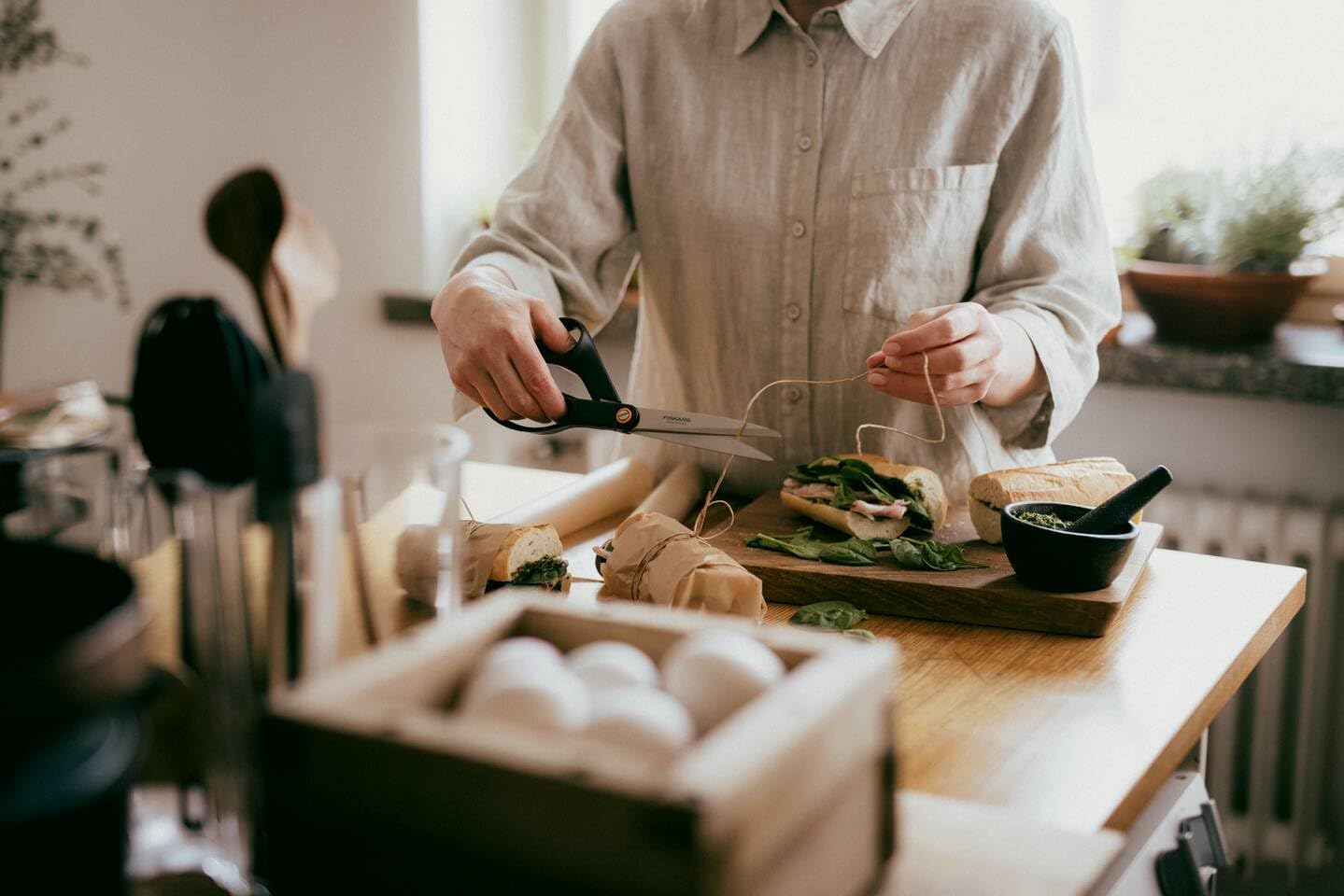 Person using Fiskars scissors to cut twine