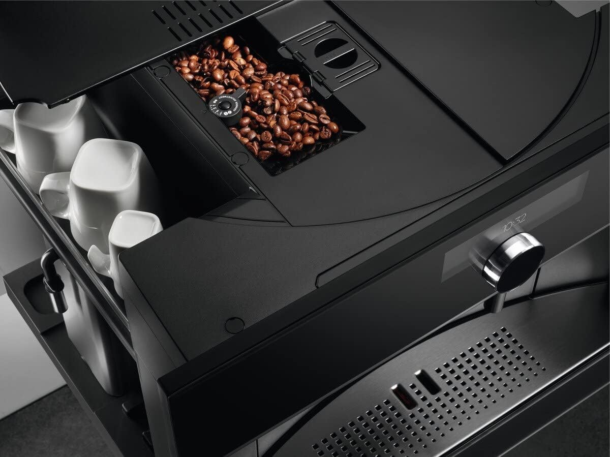 Top view of the AEG KKK994500B coffee machine showing the bean hopper filled with coffee beans