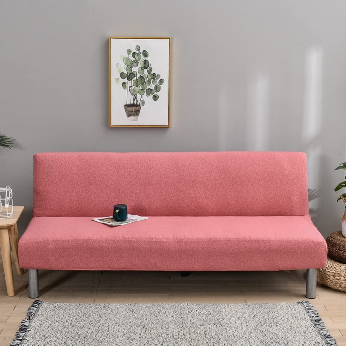 Housse futon rose pour rénover un canapé-lit usé et le protéger des taches