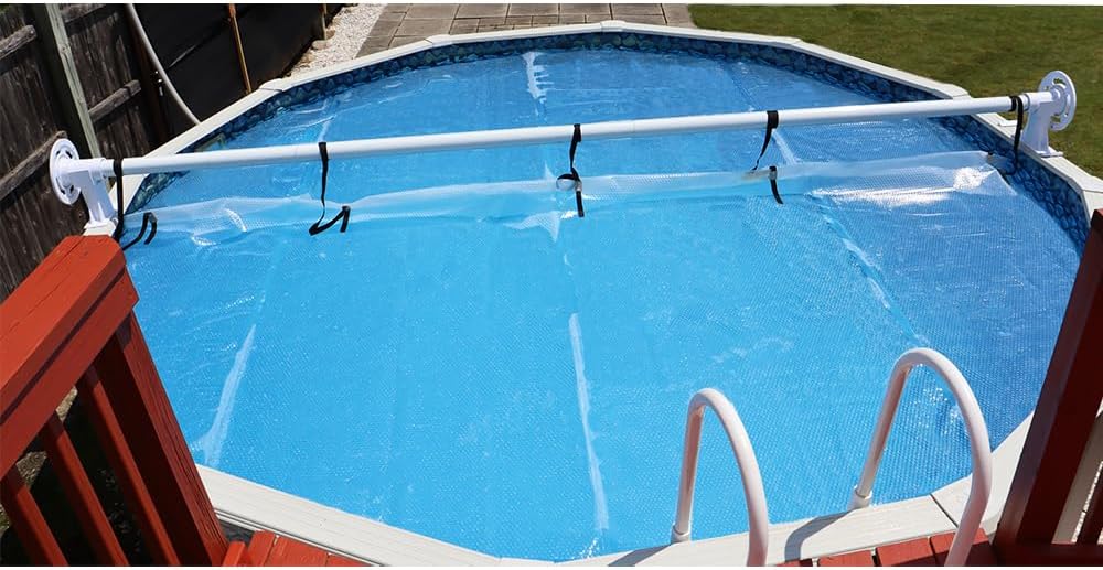 Sun2Solar Solar Cover Reel System positioned at the edge of an above-ground pool, with the solar cover partially extended over the water.